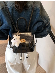 Chic black mini backpack with patent leather finish and cute bear charm for women