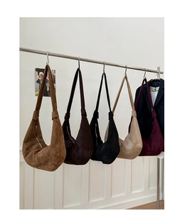 Detailed row of five large faux suede crescent hobo bags in assorted vintage colors