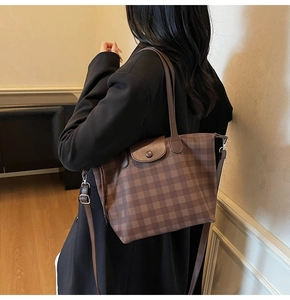 Brown checkered tote bag showing size scale and shoulder carry position for daily commute