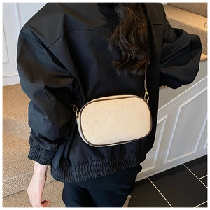 Top view of a cream matte crossbody bag with brown trim and gold metallic hardware details
