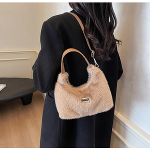 Détail du sac bandoulière en fausse fourrure marron clair avec logo en métal et texture