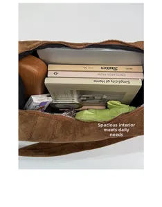 Spacious interior of dark brown suede shoulder bag showing large storage capacity