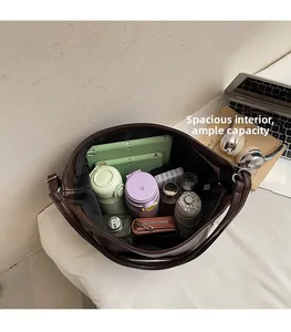 Spacious interior of retro brown leather tote bag holding a tablet and daily essentials