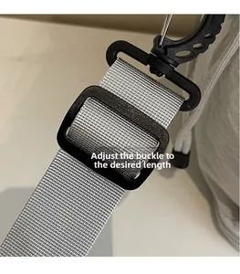 Close-up of adjustable nylon shoulder strap with buckle and metal swivel hook