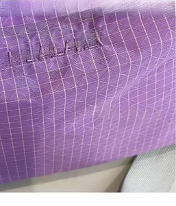 Close-up of purple tear-resistant plaid fabric and white grid texture with embroidery