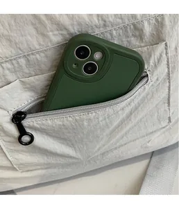 Close-up of a nylon tote bag featuring a zipper pocket with a smartphone inside