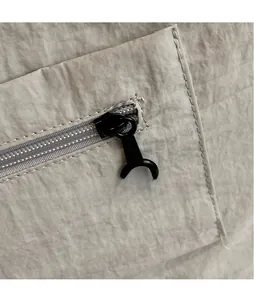 Macro shot of durable black metal zipper pull and clean stitching on the large tote bag