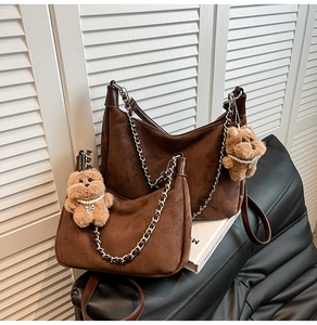 Deep brown suede crescent bags with silver chains and plush bear charms in two sizes