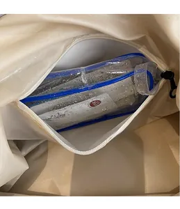 Close-up of internal waterproof dry-wet separation pocket in a beige travel tote bag