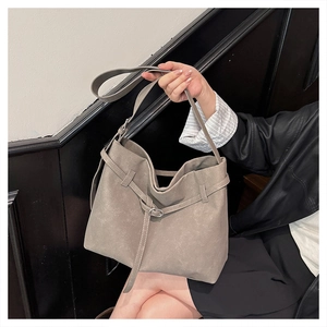 Detailed macro view of the taupe frosted suede tote bag with stylish silver metal buckles