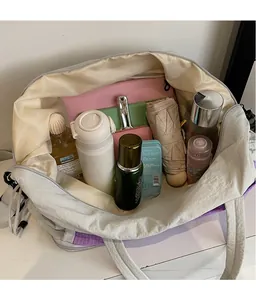 Top view of spacious grey tote interior showing water bottle and cosmetics storage