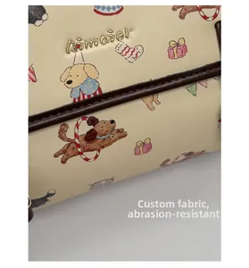 Détail du sac en cuir beige avec motifs de chiens et tissu résistant aux rayures