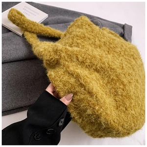 Detailed close-up of soft yellow faux fur texture on a plush tote bag for winter style
