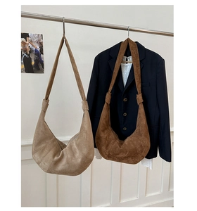 Close-up of matte hobo bags in khaki and caramel brown on a display stand