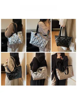 Quilted tote bag detail showcasing silver and black metallic nylon with wide straps