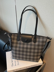 Large plaid tote bag with black leather handles and snap closure for autumn fashion
