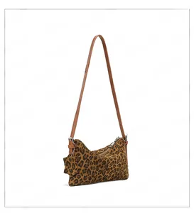 Detail of leopard print crossbody bag with thin leather strap and star charm