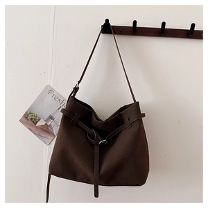 Detail of a dark brown large tote bag in matte finish with adjustable shoulder strap