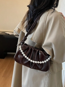 Deep brown patent leather pleated cloud bag with pearl chain and knot shoulder strap