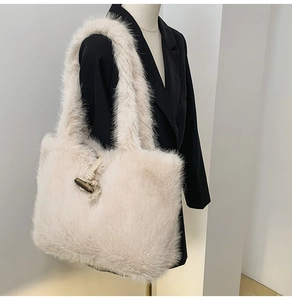 Detail einer Plüschtasche mit braunem Knebelverschluss und gewebtem Seil-Design