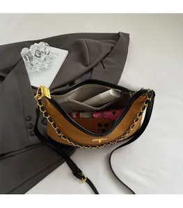 Top view of suede crescent bag showing spacious interior with pockets and gold chain