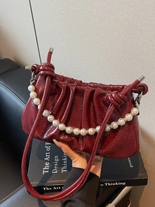 Elegant wine red pleated faux pearl shoulder bag in glossy patent leather with strap