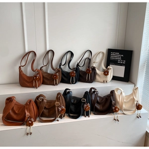 Various sizes and colors of versatile women's shoulder bags with cute monster charms