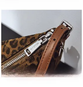 Detailed macro view of the leopard print bag with polished silver metal zipper hardware