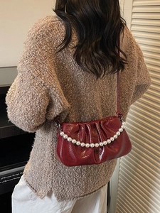 Chic burgundy pleated cloud crossbody bag with elegant pearl chain and soft leather finish