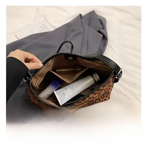Interior view of leopard print tote bag with inner pocket and magnetic closure detail