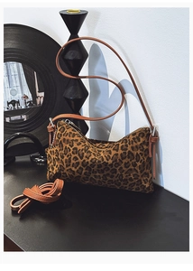 Leopard print velvet shoulder bag with brown leather straps and metal hardware detail