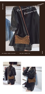 Detail view of a small leopard print crossbody bag with brown leather strap and zipper