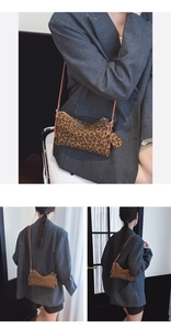 Close-up of leopard print crossbody bag with silver zipper and leather star charm