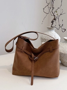 Minimalist deep brown frosted leather tote bag with unique buckle and knot shoulder strap