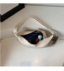Interior view of off-white faux leather hobo bag showing large storage capacity