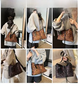 Detail view of large leopard print tote bag with black straps and minimalist design