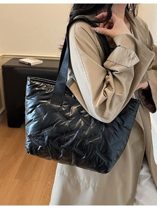 Quilted black tote bag with glossy nylon finish and spacious design for daily commute
