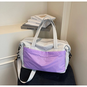 Macro detail of purple checkered front pocket on light gray nylon large travel tote bag