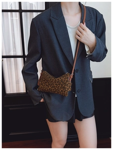 Classic leopard print crossbody bag with brown strap styled on a grey blazer outfit
