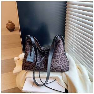 Detail of vintage leopard print tote bag with brown faux leather strap and fashion tag