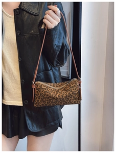 Chic vintage leopard print underarm bag with sleek leather strap and polished metal zipper