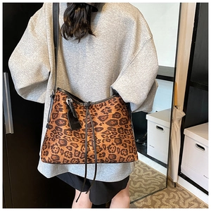 Detail of leopard print tote bag with black leather straps and Fashion brand tag