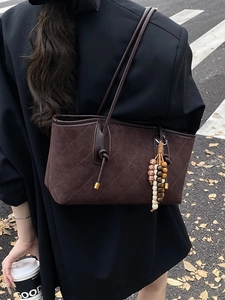 Vintage dark brown suede tote bag with quilted pattern and wooden bead pendant