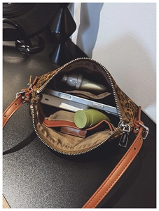 Interior view of leopard print crossbody bag showing spacious storage and inner pockets
