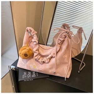 Pink nylon pleated shoulder bag with bow detail and cute teddy bear plush charm