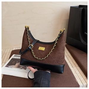 Detail of rhombic quilted crossbody bag with frosted texture and gold chain strap