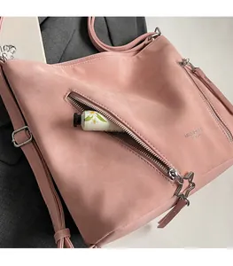Pink tote bag with star-shaped zipper front pocket showing hand cream storage