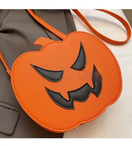 Close-up of bright orange pumpkin crossbody bag with textured faux leather finish