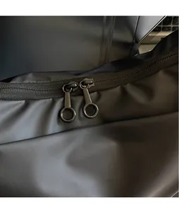 Detailed macro view of dual smooth black metal circular zippers on durable oxford fabric