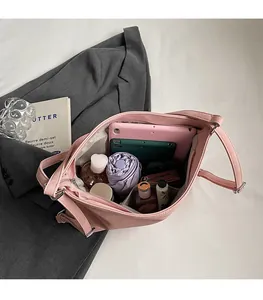 Macro view of a large pink tote bag interior showing spacious compartments for gadgets